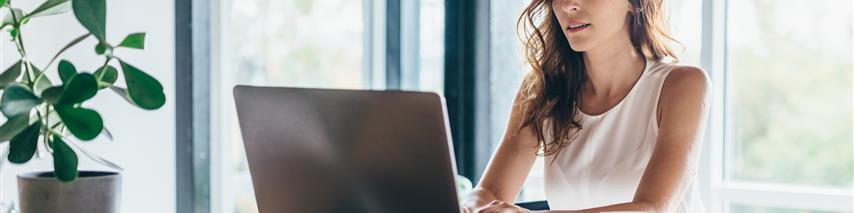 Young women in house using her laptop to research into insurance